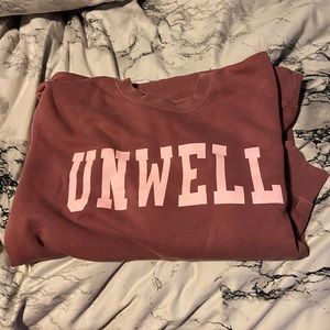 Call her daddy crew neck “UNWELL”.